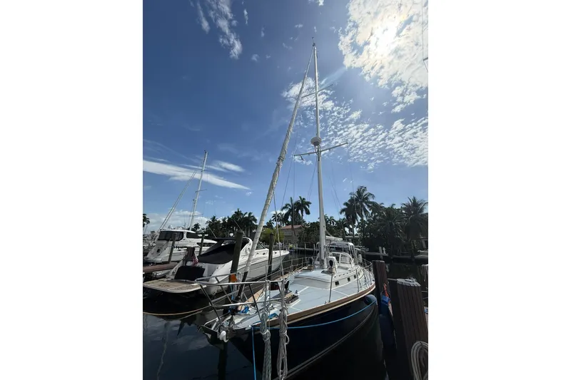 Slide: The Image of 1986 Little Harbor LH46 sailboat docked under a sunny sky with palm trees. - 8