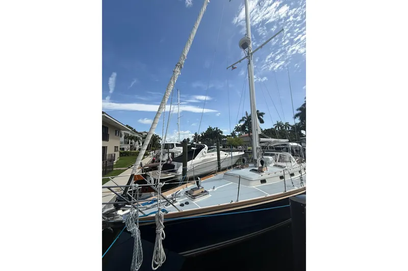 Slide: The Image of 1986 Little Harbor LH46 sailboat docked under a clear blue sky. - 9