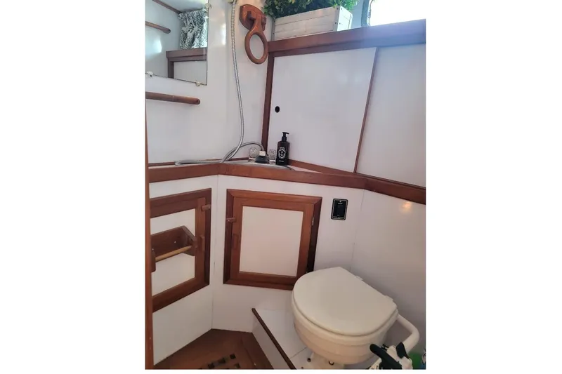 Slide: The Image of 1987 Albin 37 Palm Beach yacht bathroom with wooden accents and modern fixtures. - 11