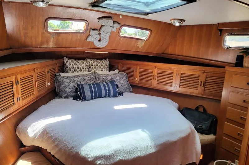Slide: The Image of Interior of 1987 Albin 37 Palm Beach yacht with wooden cabinets and cozy seating area. - 12