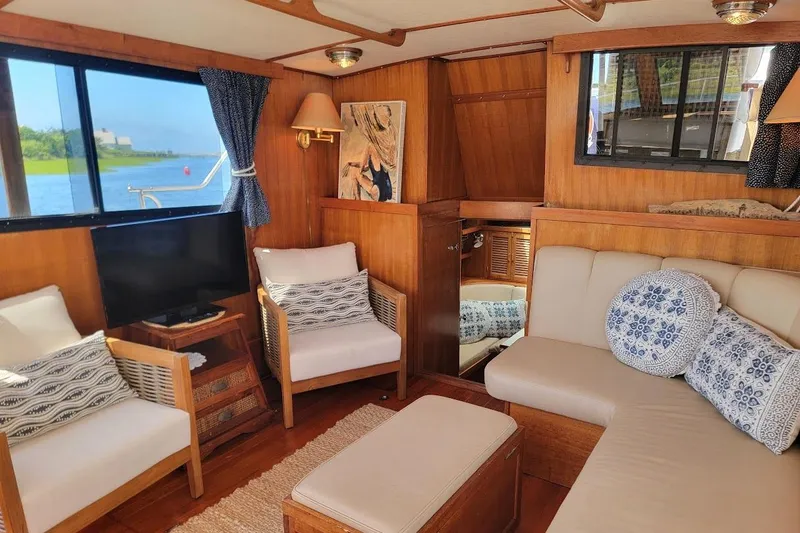 Slide: The Image of Cozy interior of 1987 Albin 37 Palm Beach yacht with elegant wood finish and seating area. - 13