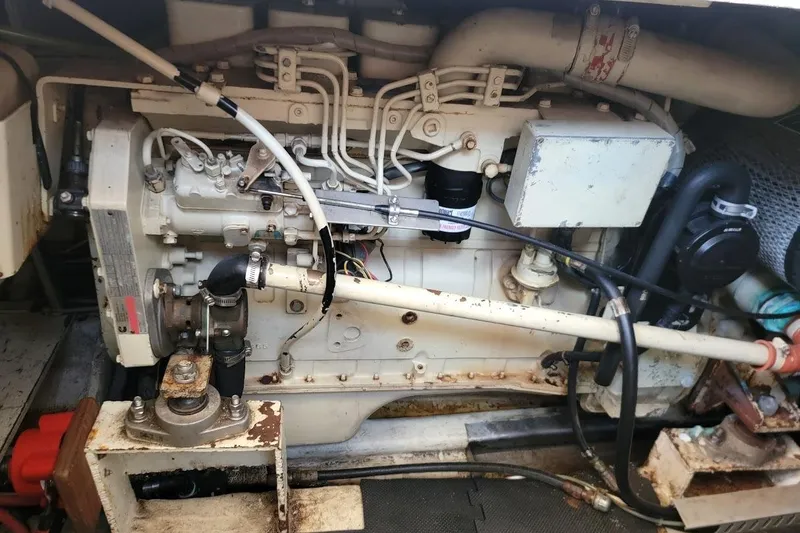 Slide: The Image of Engine compartment of a 1987 Albin 37 Palm Beach boat, showcasing mechanical components. - 17