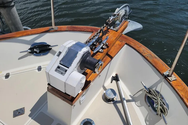 Slide: The Image of 1987 Albin 37 Palm Beach boat deck with anchor winch and wooden trim. - 24