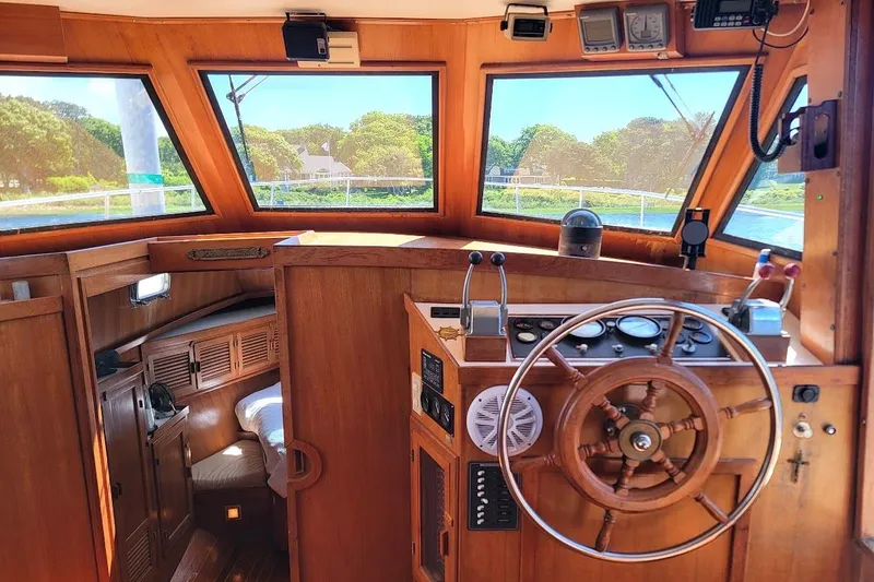Slide: The Image of Interior of 1987 Albin 37 Palm Beach boat with wooden helm and navigation instruments. - 25