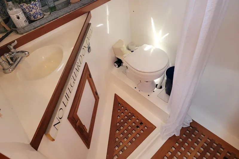 Slide: The Image of Bathroom interior of 1987 Albin 37 Palm Beach boat with sink and toilet. - 28