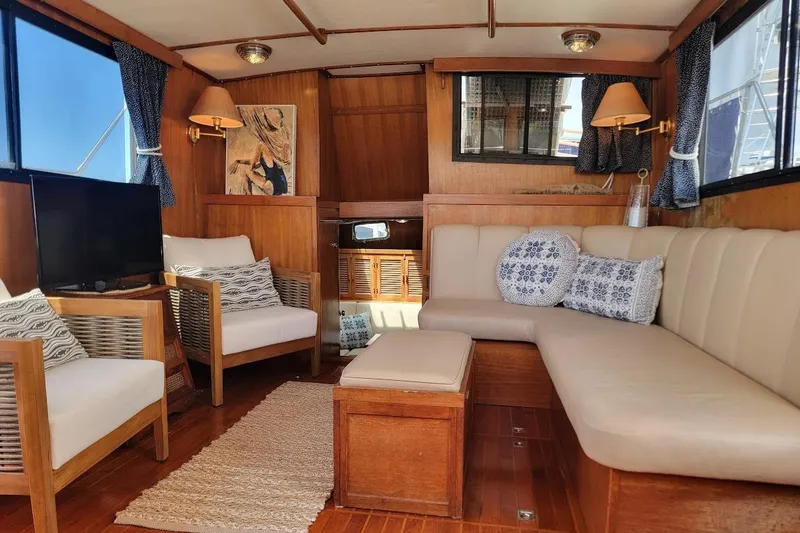 Slide: The Image of Interior of 1987 Albin 37 Palm Beach yacht with cozy seating and nautical decor. - 29
