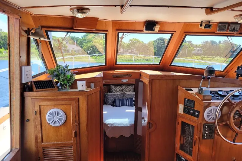 Slide: The Image of Interior of 1987 Albin 37 Palm Beach boat with cozy cabin and wooden helm. - 3
