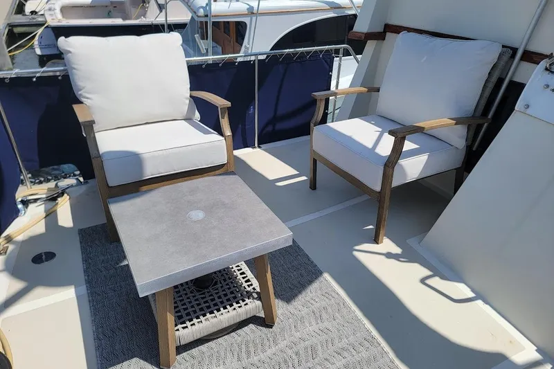 Slide: The Image of Outdoor seating area on 1987 Albin 37 Palm Beach yacht with cushioned chairs and table. - 31