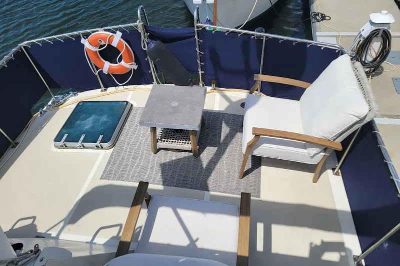 Slide: The Image of 1987 Albin 37 Palm Beach yacht deck with seating, table, and life preserver. - 35