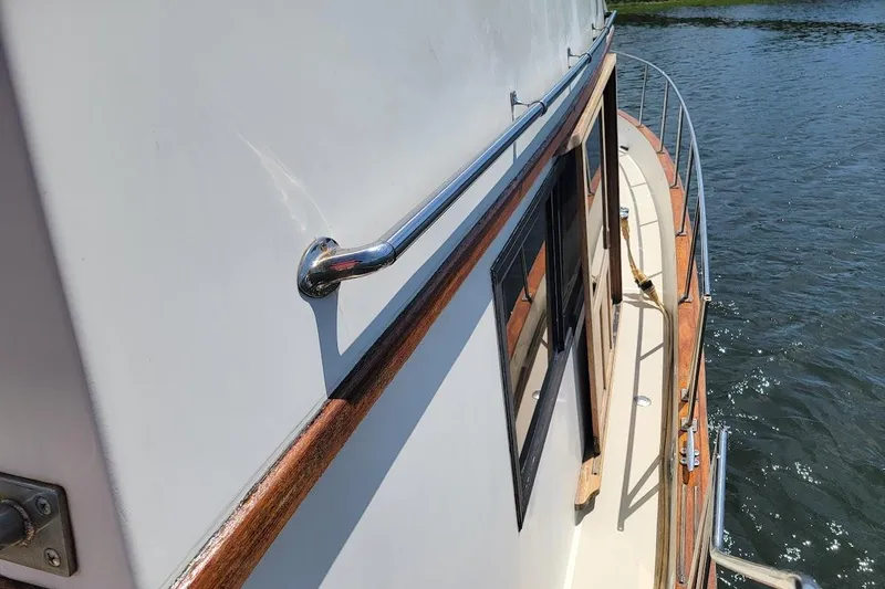 Slide: The Image of 1987 Albin 37 Palm Beach yacht with wooden railings on water. - 36