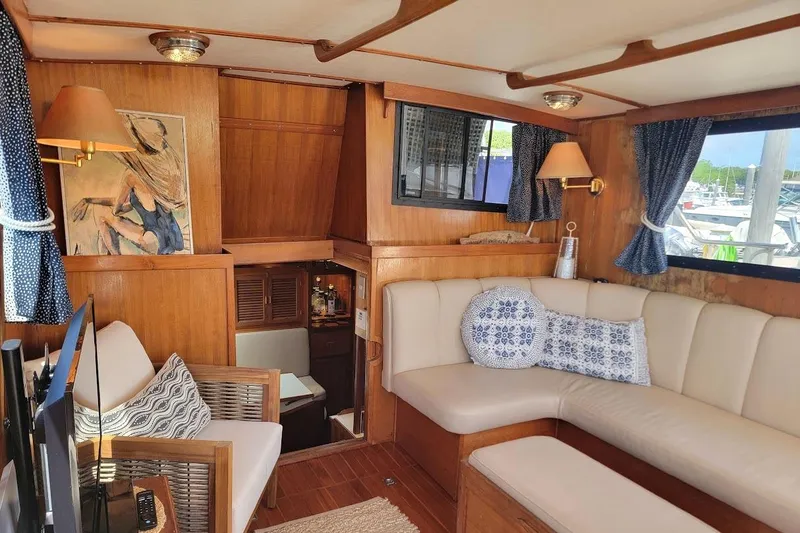 Slide: The Image of Interior of 1987 Albin 37 Palm Beach yacht with cozy seating and nautical decor. - 7