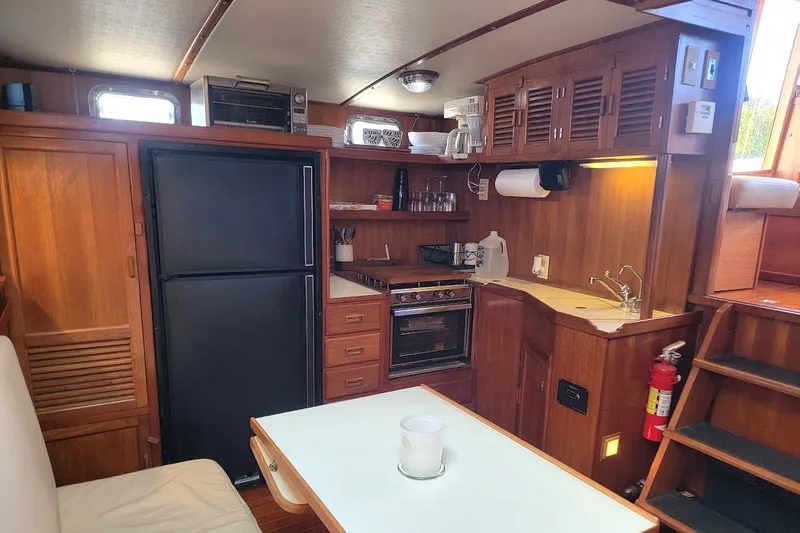 Slide: The Image of Interior of 1987 Albin 37 Palm Beach yacht with kitchen and dining area. - 8