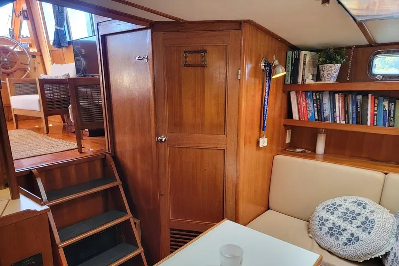 Slide: The Image of Interior of 1987 Albin 37 Palm Beach yacht with wooden decor and cozy seating area. - 9
