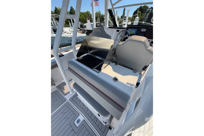 Slide: The Image of 2024 Solara S-250 CW boat interior with helm, grill, and seating area. - 13