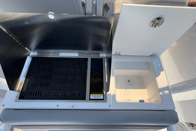 Slide: The Image of 2024 Solara S-250 CW boat grill and sink setup, featuring Kenyon grill and storage compartment. - 14