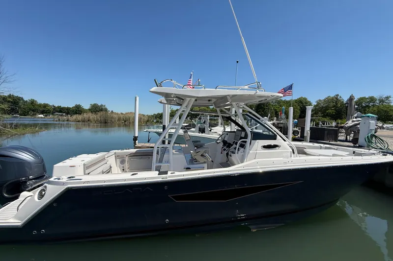 Slide: The Image of 2024 Solara S-250 CW boat docked in a serene marina setting. - 2