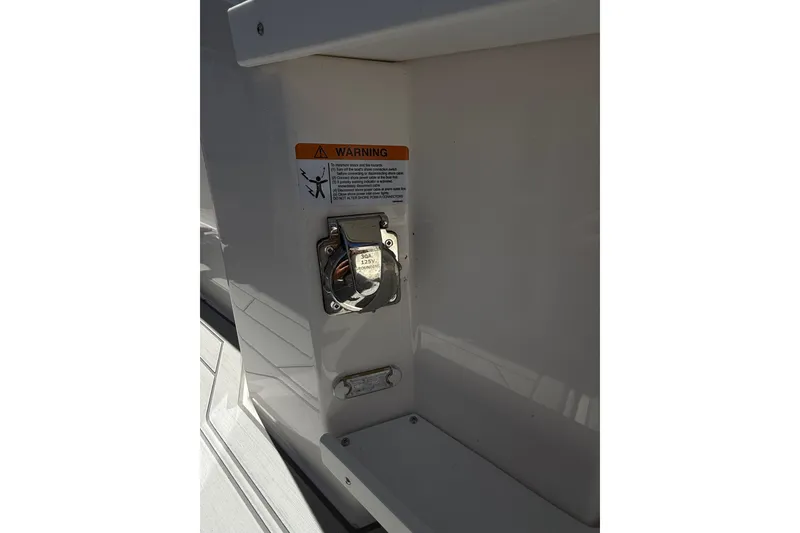 Slide: The Image of 2024 Solara S-250 CW boat power outlet with warning label. - 33
