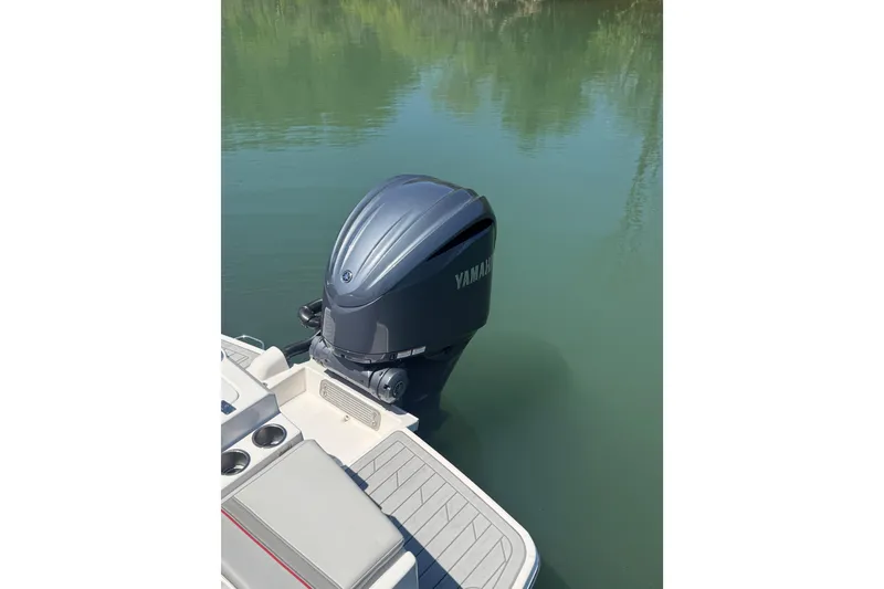 Slide: The Image of 2024 Solara S-250 CW boat with Yamaha outboard motor on calm water. - 4