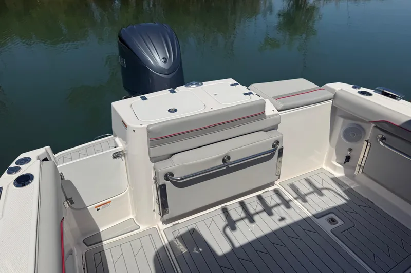 Slide: The Image of 2024 Solara S-250 CW boat deck with seating and motor, on calm water. - 6