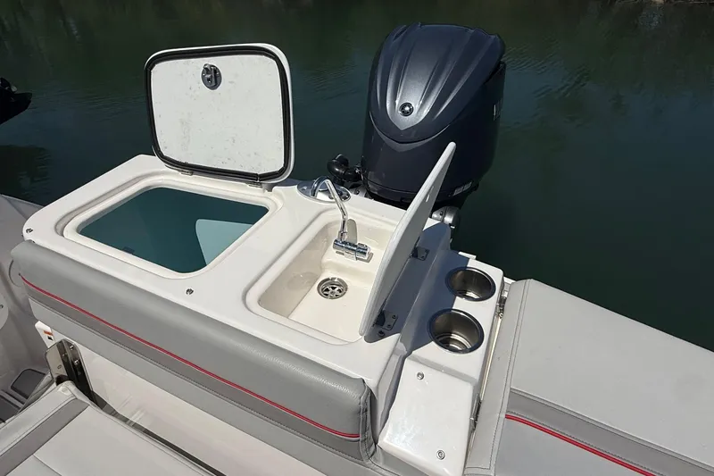 Slide: The Image of 2024 Solara S-250 CW boat with open storage compartment and motor. - 7