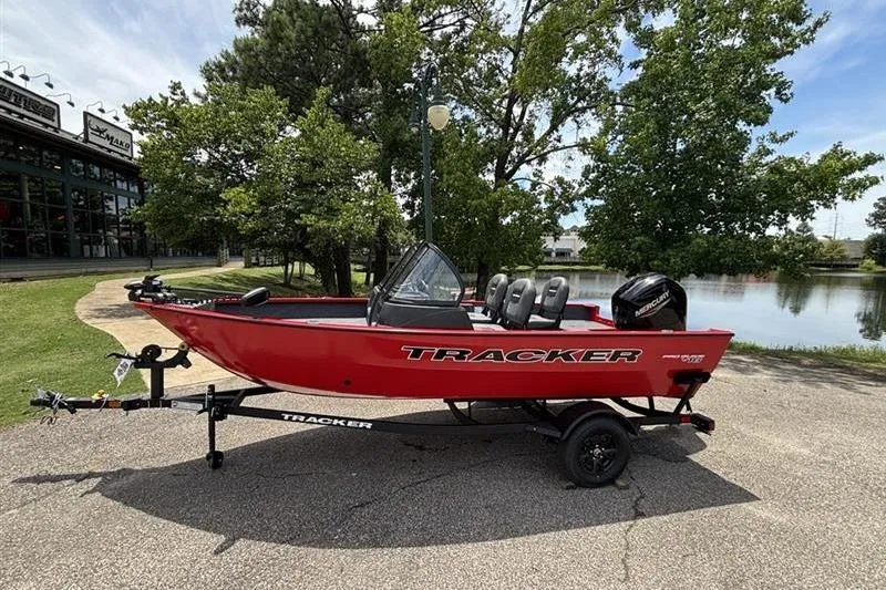 The Image of 2026 Tracker Pro Guide V-16 WT boat on trailer by a lake. - 0
