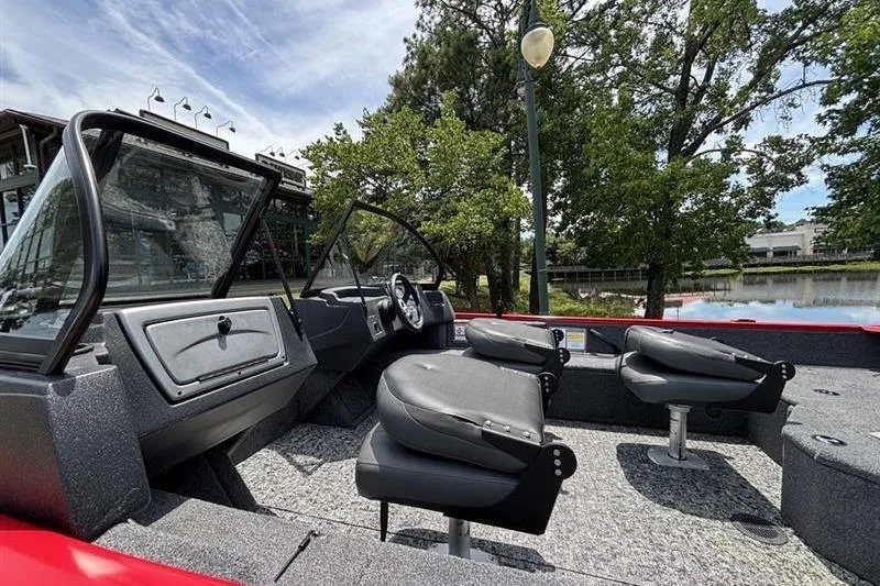 Slide: The Image of 2026 Tracker Pro Guide V-16 WT boat interior with seating and steering console. - 7