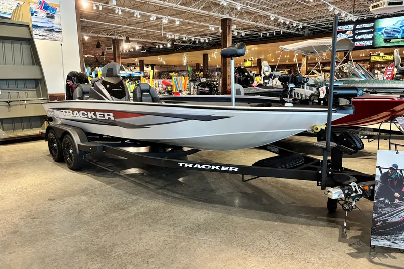 The Image of 2026 Tracker Savage 215 boat displayed in a showroom, featuring sleek design and modern equipment. - 0