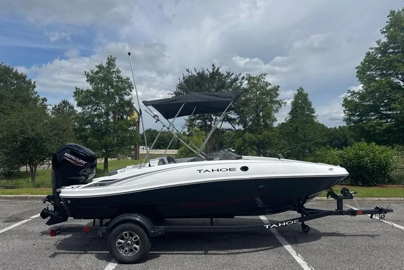 The Image of 2026 Tahoe T16 boat on trailer, parked outdoors under cloudy sky. - 0