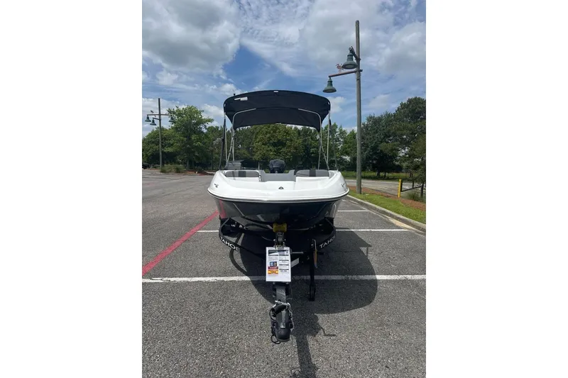 Slide: The Image of 2026 Tahoe T16 boat parked outdoors under a cloudy sky. - 1