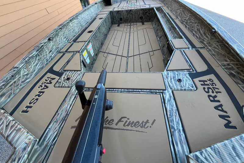Slide: The Image of 2026 Tracker Grizzly 1756 T Marsh boat interior with camo design and "Marsh 1756" branding. - 2