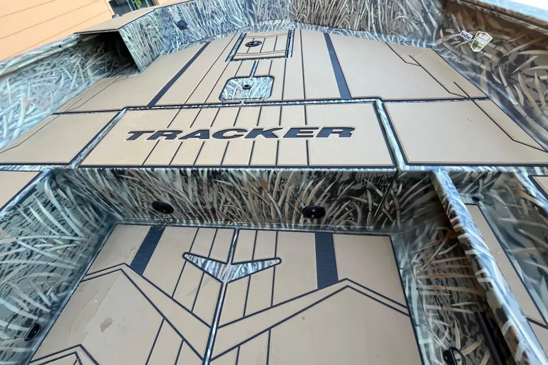 Slide: The Image of 2026 Tracker Grizzly 1756 T Marsh boat interior with camo design and logo. - 3