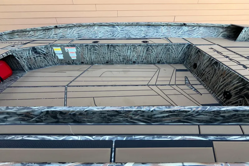 Slide: The Image of 2026 Tracker Grizzly 1756 T Marsh boat interior with camouflage design and spacious deck. - 4