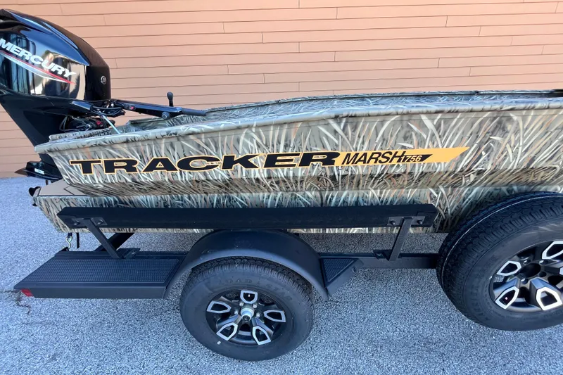 Slide: The Image of 2026 Tracker Grizzly 1756 T Marsh boat with camouflage design on trailer. - 6