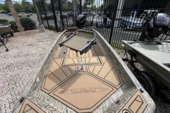 Slide: The Image of 2026 Tracker Grizzly 1650 T Prairie Wings Edition boat with camouflage design, parked outdoors. - 8