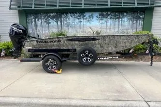 The Image of 2026 Tracker Grizzly 1650 T Prairie Wings Edition boat on trailer, side view. - 0