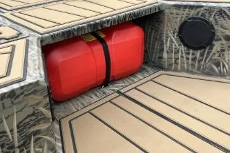 Slide: The Image of 2026 Tracker Grizzly 1650 T Prairie Wings Edition boat interior with red fuel tank. - 2