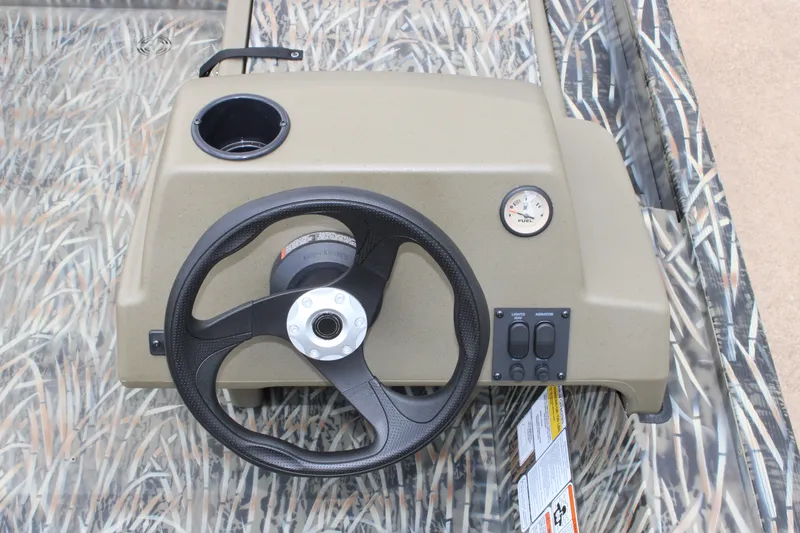 Slide: The Image of Steering console of 2026 Tracker Grizzly 1754 SC boat with camo design. - 8