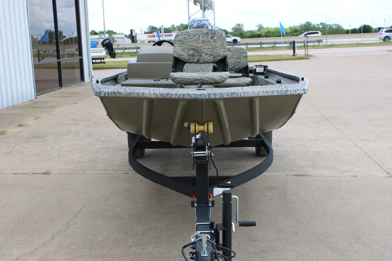 Slide: The Image of 2026 Tracker Grizzly 1754 SC boat on trailer, parked outdoors. - 2
