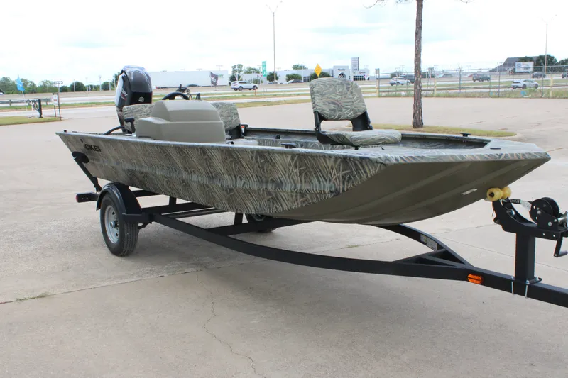 Slide: The Image of 2026 Tracker Grizzly 1754 SC boat on trailer, featuring camouflage design and seating. - 3