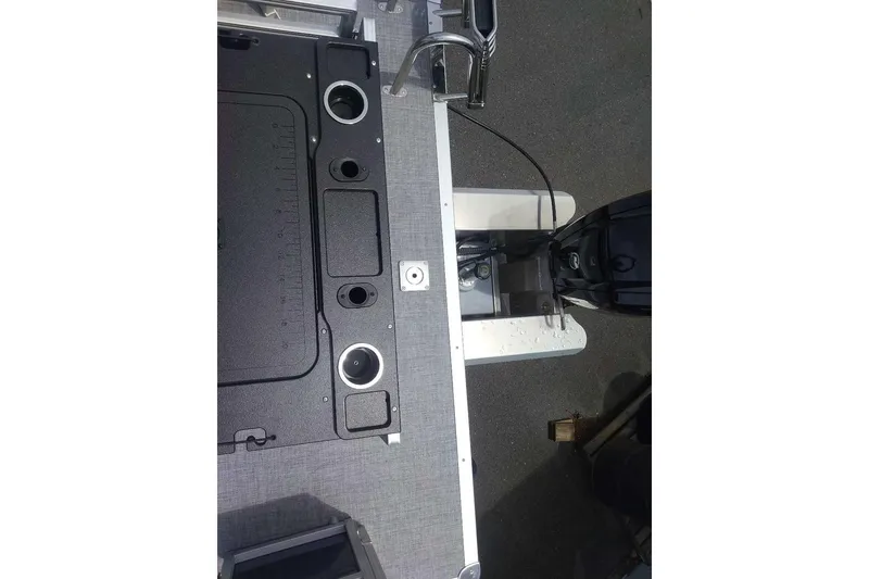 Slide: The Image of 2026 Sun Tracker SportFish 20 DLX boat deck with motor and cup holders. - 6