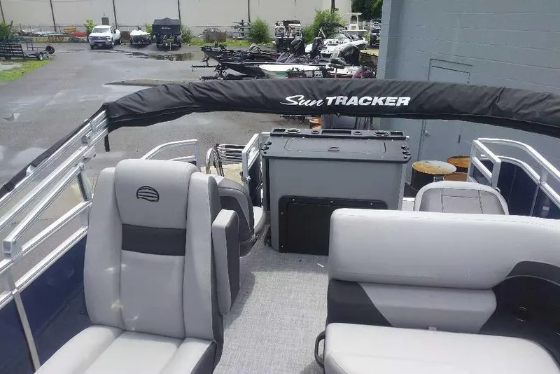 Slide: The Image of 2026 Sun Tracker SportFish 20 DLX pontoon boat interior with seating and console. - 7