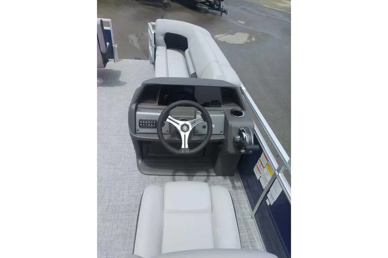 Slide: The Image of 2026 Sun Tracker SportFish 20 DLX boat interior with steering console and seating. - 9