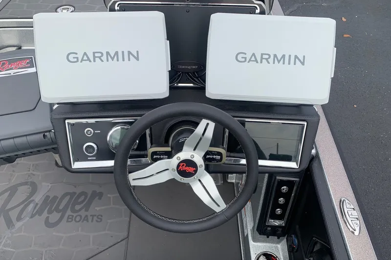 Slide: The Image of 2026 Ranger Z520R Cup-Equipped boat dashboard with Garmin displays and steering wheel. - 7
