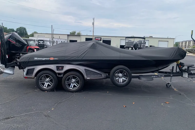 Slide: The Image of 2026 Ranger Z520R Cup-Equipped boat covered on a trailer in a parking lot. - 4