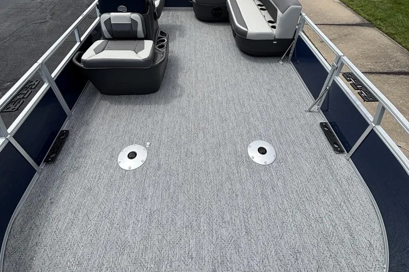 Slide: The Image of 2026 Sun Tracker Bass Buggy 16 XL Select pontoon boat interior with seating and carpeted deck. - 1