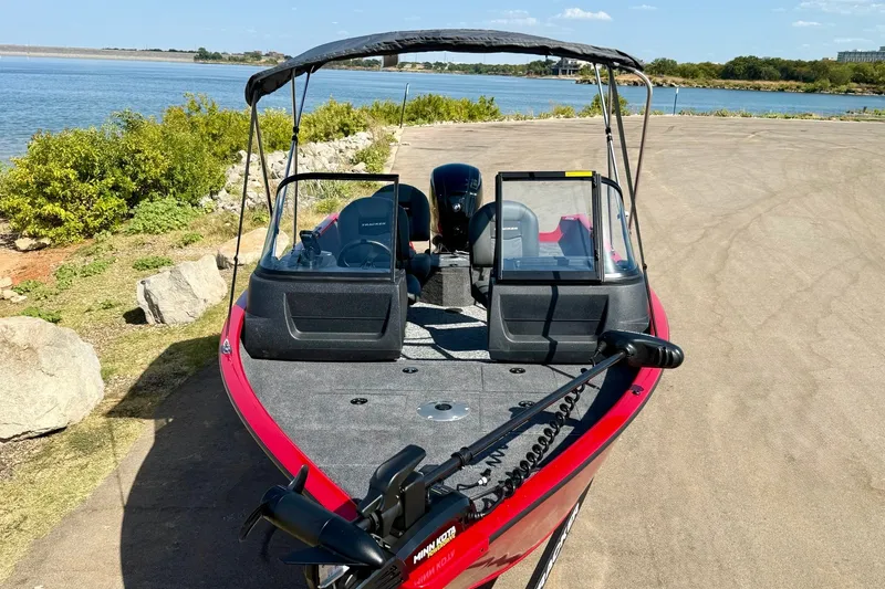 Slide: The Image of 2026 Tracker Pro Guide V-16 WT boat parked by a scenic lakeside. - 15