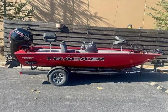 The Image of 2026 Tracker Pro Team 190 boat in red, parked on a trailer outdoors. - 0