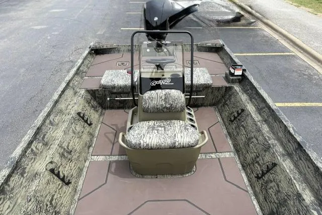 Slide: The Image of 2026 Tracker Grizzly 2072 CC boat with camouflage seating and steering console. - 13