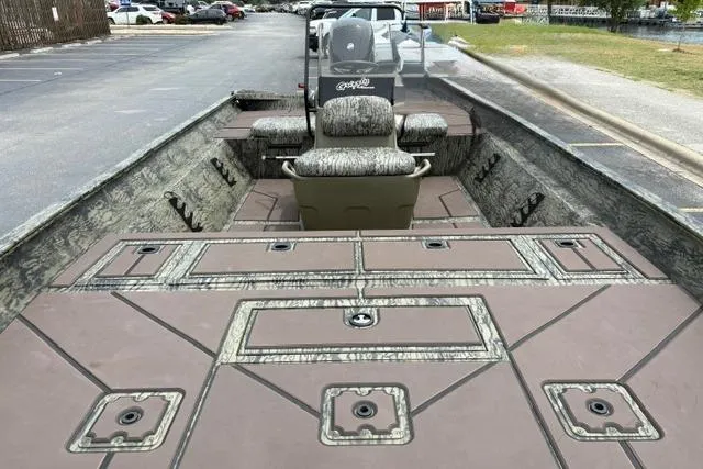 Slide: The Image of 2026 Tracker Grizzly 2072 CC boat with spacious deck and camo seating in a parking lot. - 15