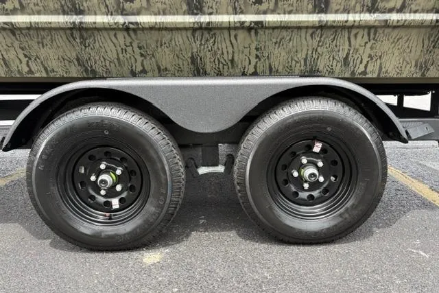 Slide: The Image of 2026 Tracker Grizzly 2072 CC trailer wheels on asphalt pavement. - 25